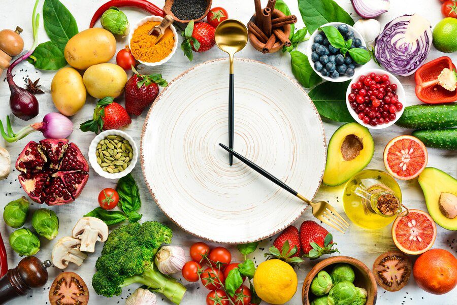 concept-dietary-nutrition-fresh-vegetables-fruits-cutlery-plate-form-clock-top-view-free-space-your-text_187166-56448